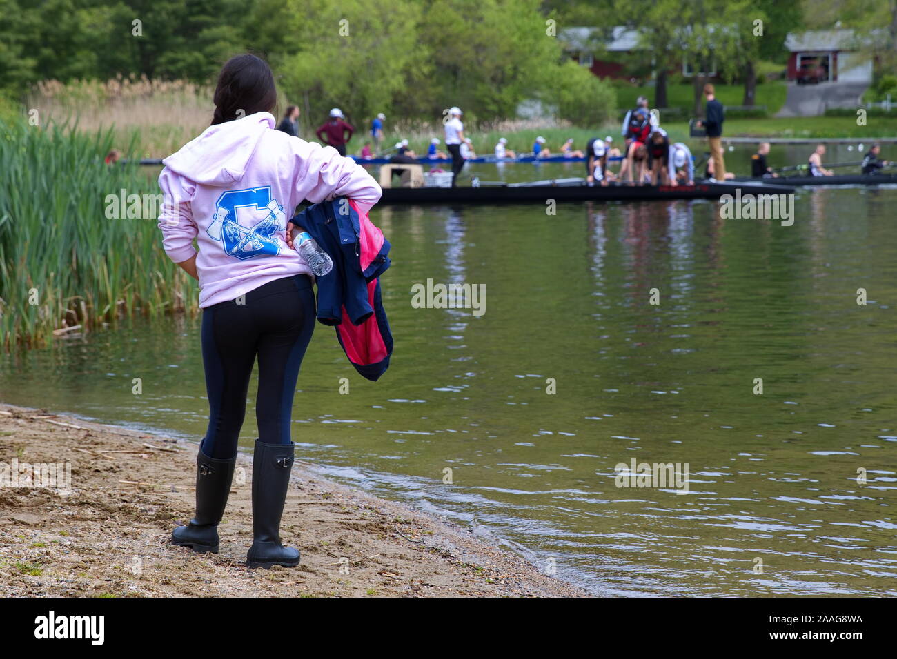 New Preston, CT USA. May 2016. Crew member waiting by river shore to
