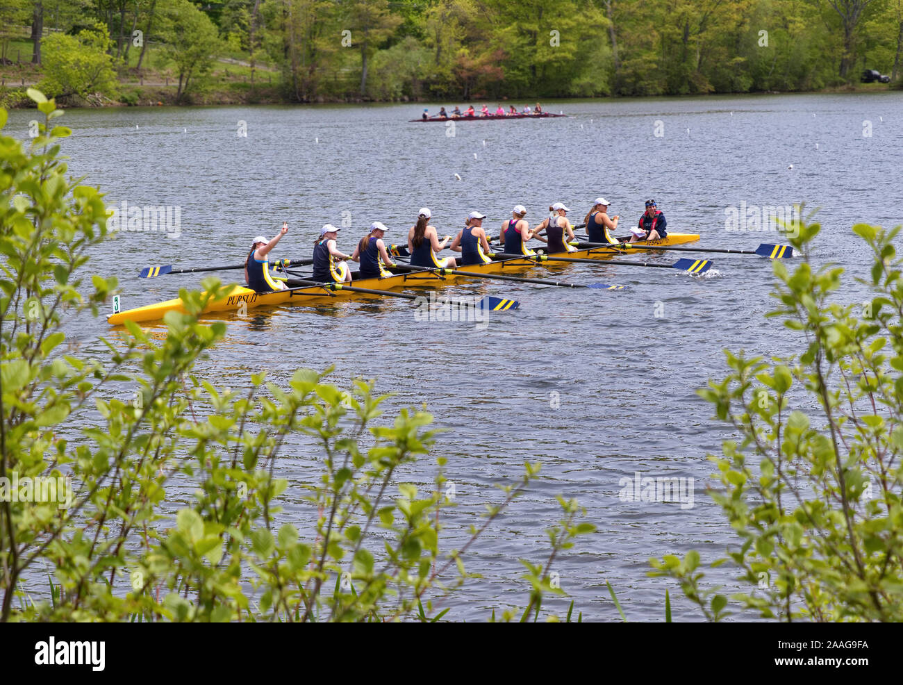 New Preston, CT USA. May 2016. Crew rowers smiling and waving to