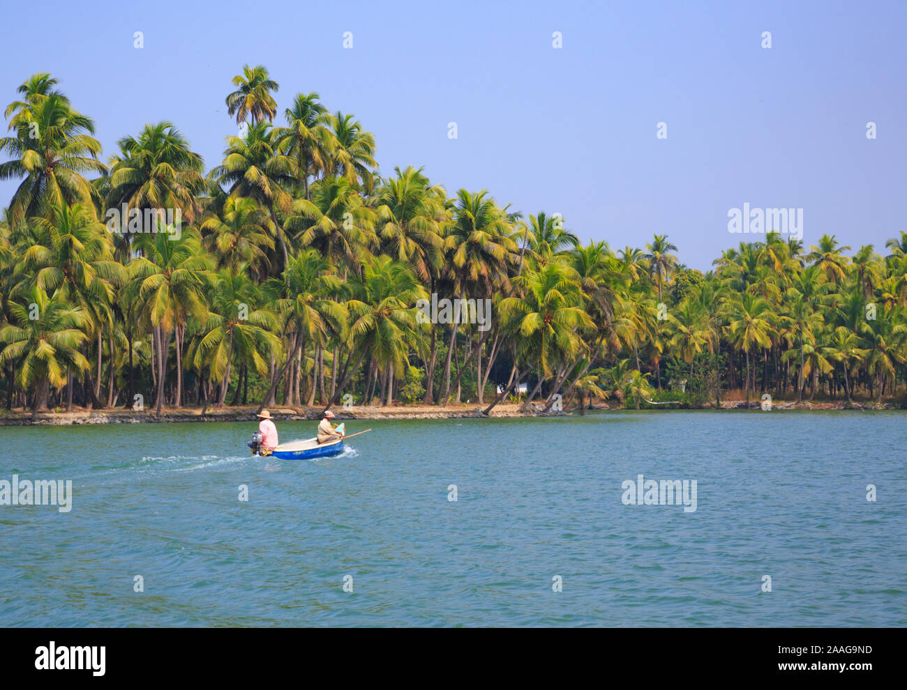 Two people angling from a boat in Suvarna river (Karnataka, India) Stock Photo
