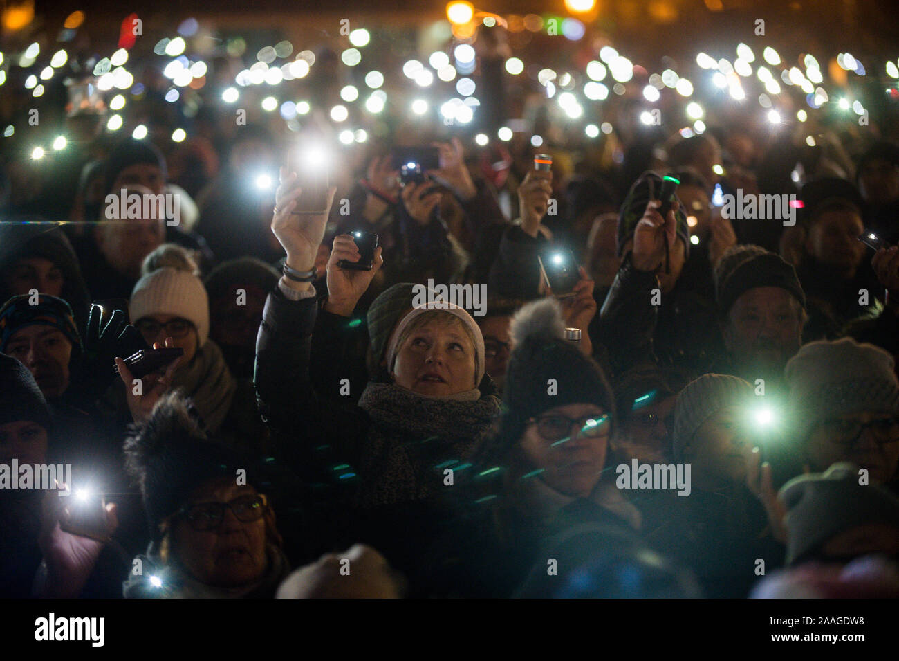 Protesters use phones to shine light during the demonstration called Light to heaven for Pawel Adamowicz at the Coal Market in Gdansk.  Mayor of Gdansk, Pawel Adamowicz was stabbed on stage while attending a charity event in Gdansk on 13 January and died a day later of his injuries. Stock Photo