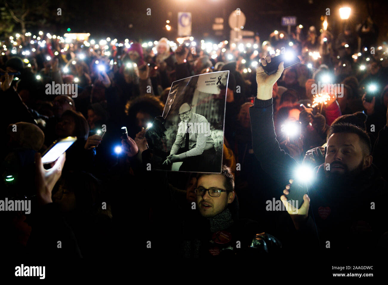 Protesters use phones to shine light during the demonstration called Light to heaven for Pawel Adamowicz at the Coal Market in Gdansk.  Mayor of Gdansk, Pawel Adamowicz was stabbed on stage while attending a charity event in Gdansk on 13 January and died a day later of his injuries. Stock Photo