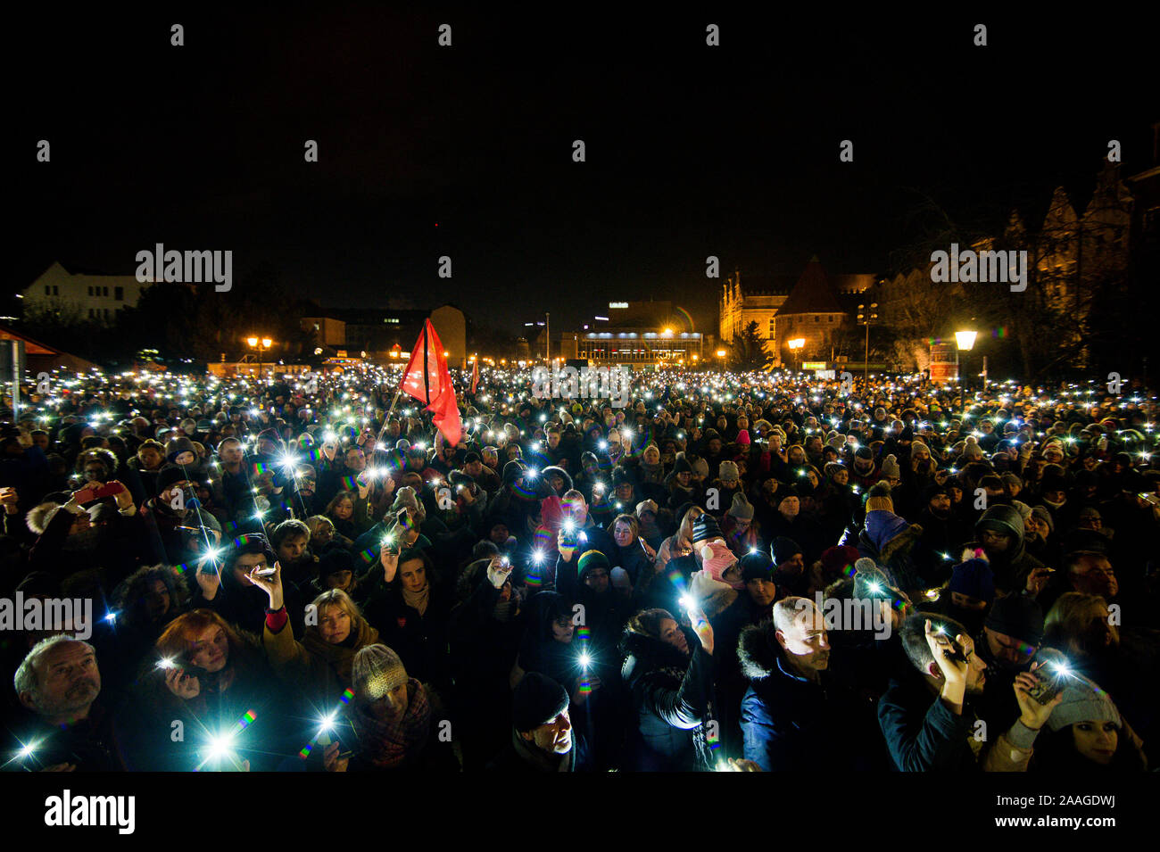 Protesters use phones to shine light during the demonstration called Light to heaven for Pawel Adamowicz at the Coal Market in Gdansk.  Mayor of Gdansk, Pawel Adamowicz was stabbed on stage while attending a charity event in Gdansk on 13 January and died a day later of his injuries. Stock Photo