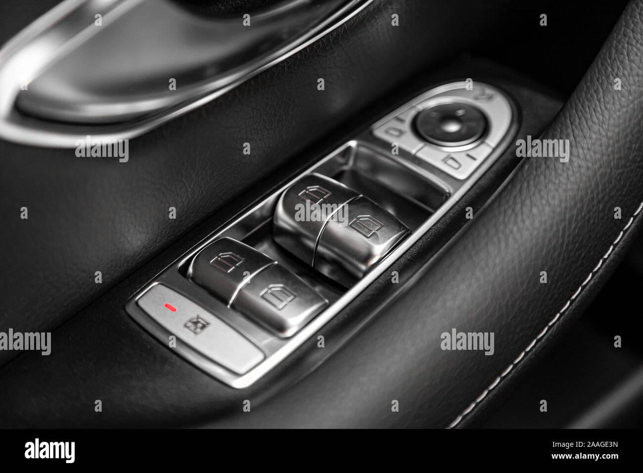 Close up of a door control panel in a new modern car. Arm rest with