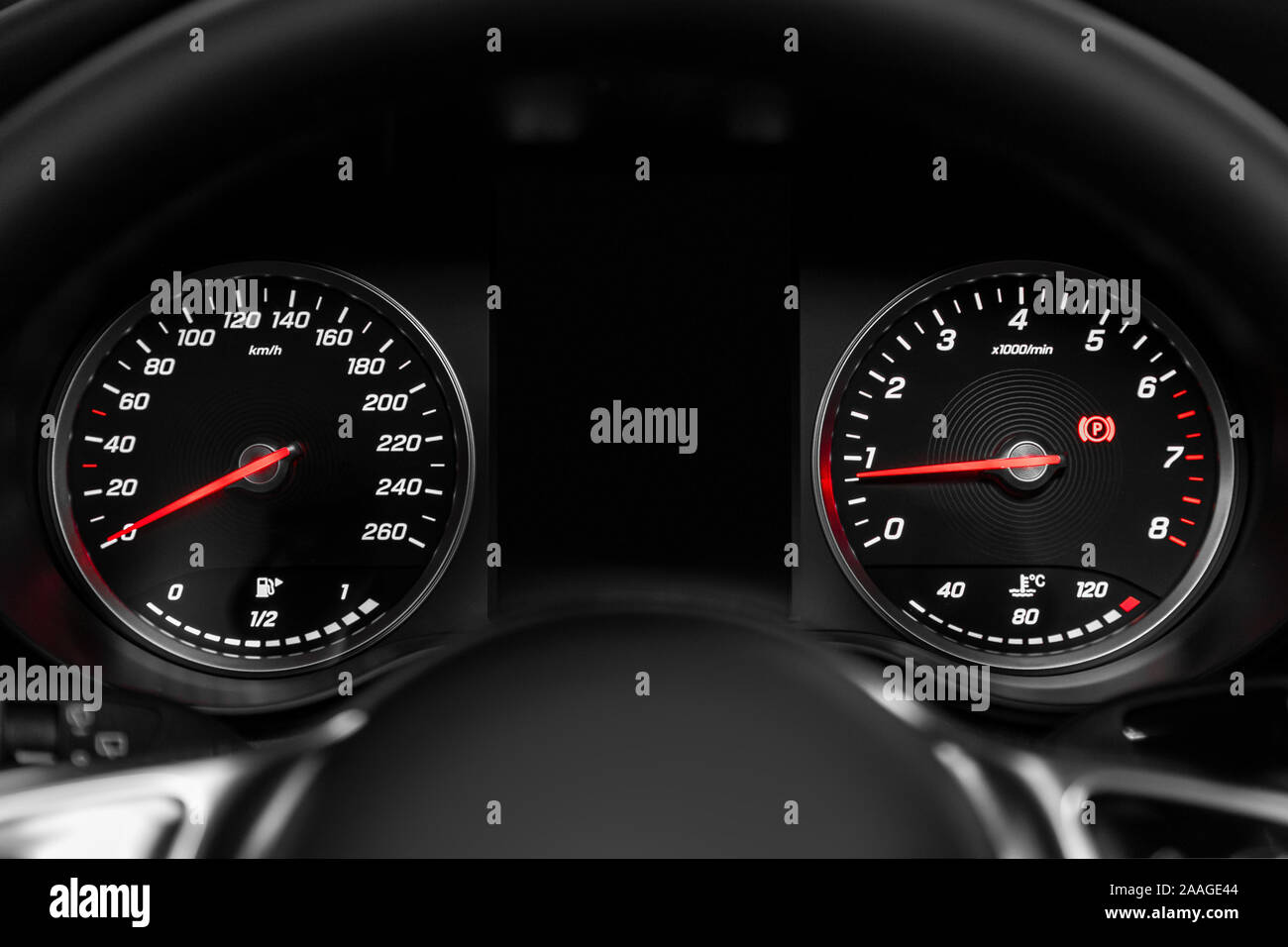 closeup of round dashboard, speedometer and tachometer with white