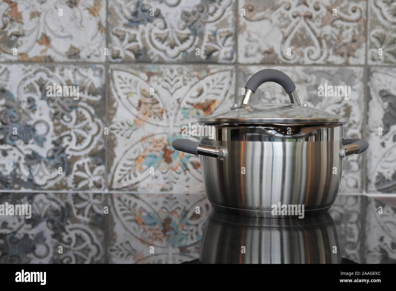 Steel saucepan on the ceramic hob Stock Photo Alamy