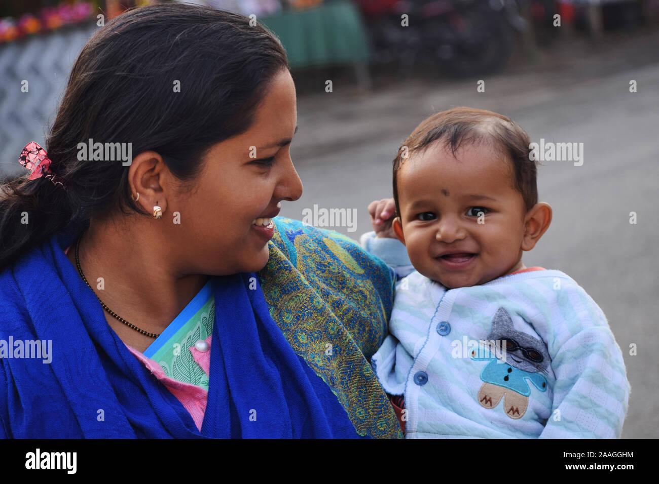 Cute Baby boy with mother looking at camera smiling, Assam, India Stock Photo