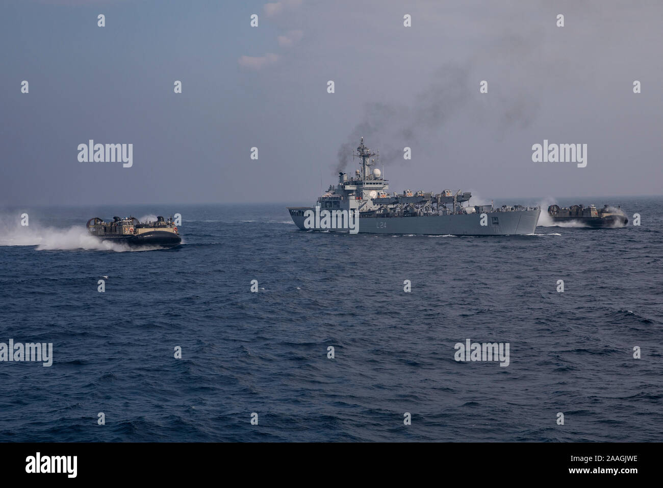 U.S. landing craft air cushions sail by the INS Jalashwa (L41) during exercise Tiger TRIUMPH in the Bay of Bengal, Nov. 17, 2019. During Tiger TRIUMPH, U.S. and Indian forces conducted valuable training in humanitarian assistance disaster relief operations by inserting a joint and combined Indian and U.S. force from ship-to-shore in response to a hypothetical natural disaster. While on shore, the forces conducted limited patrolling, moved simulated victims to medical care and produced and distributed drinking water. Military exercises like Tiger TRIUMPH improve partnership, readiness and coope Stock Photo