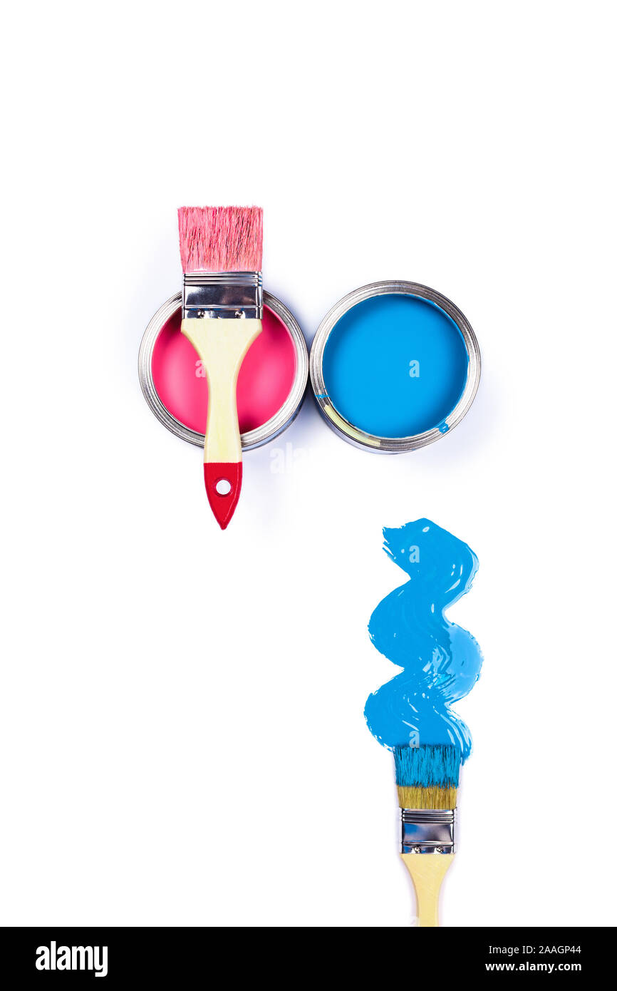 Renovation concept. White background with two color paint jars and brushes, pink brush stroke. Flat lay, top view. Central composition. Stock Photo