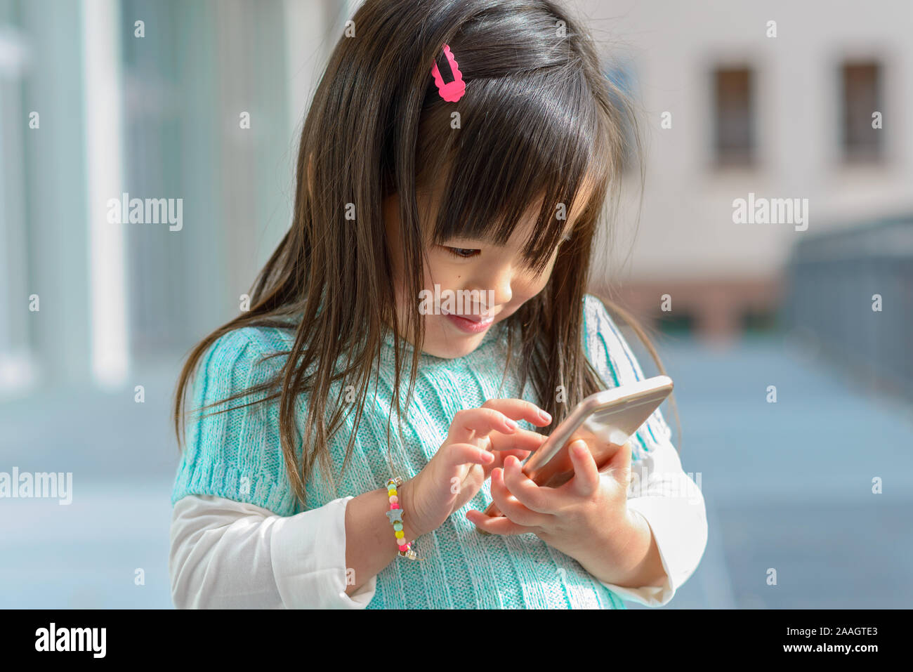 Free Photo  Happy beautiful girl playing mobile video game, holding  smartphone horizontally, watching on cellphone with excited face, pink  background.