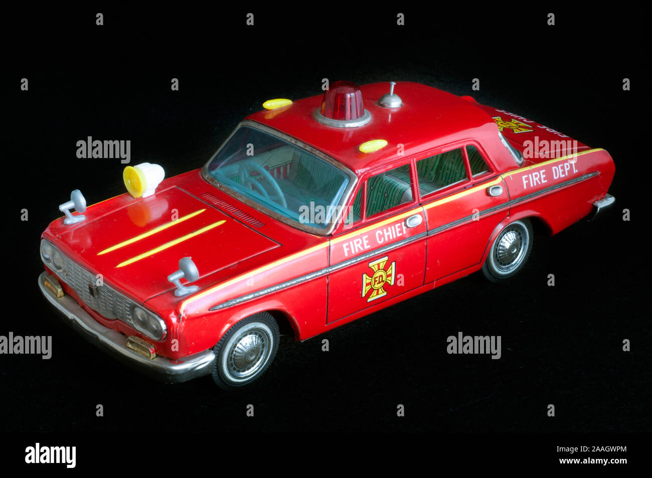 A beautiful red vintage  tin toy fire engine on a black background Stock Photo