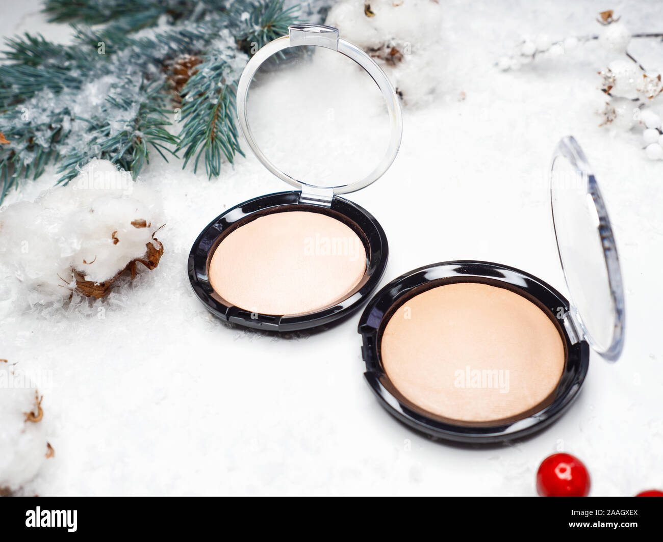 Christmas makeup and skin care. Winter makeup, new cosmetics, products for beauty and festive image. Powder, highlighter or Foundation. Stock Photo