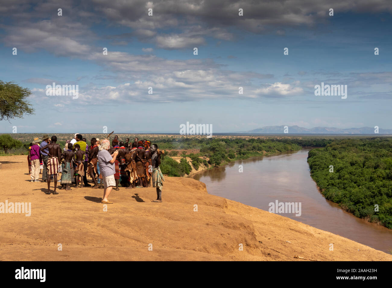 Ethiopia, South Omo, Kolcho Village traditionally dressed Karo tribespeople on cliff above above Omo River posing for tourist pictures Stock Photo