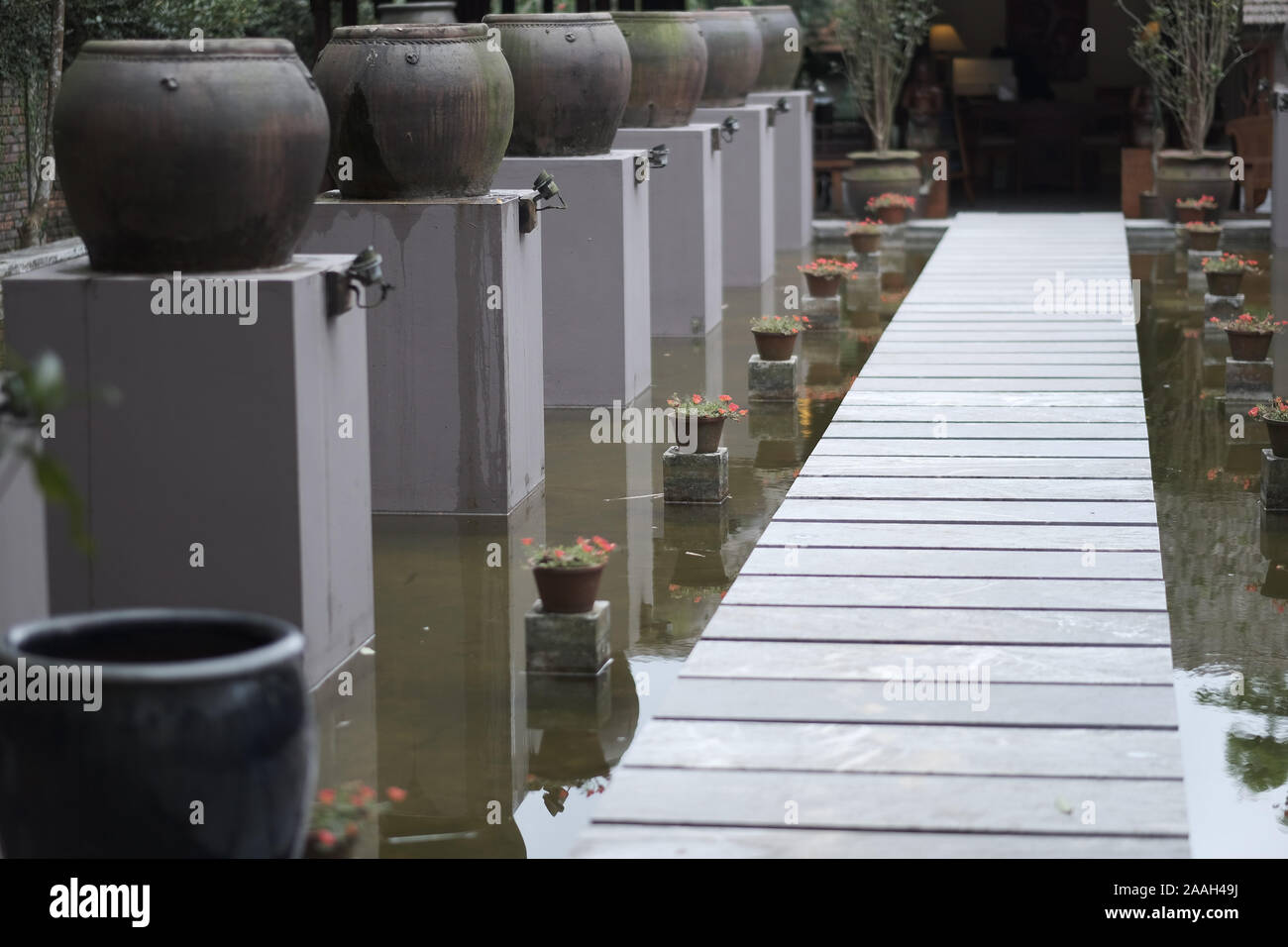 Stone path for passage to the pagoda standing on the water Stock Photo