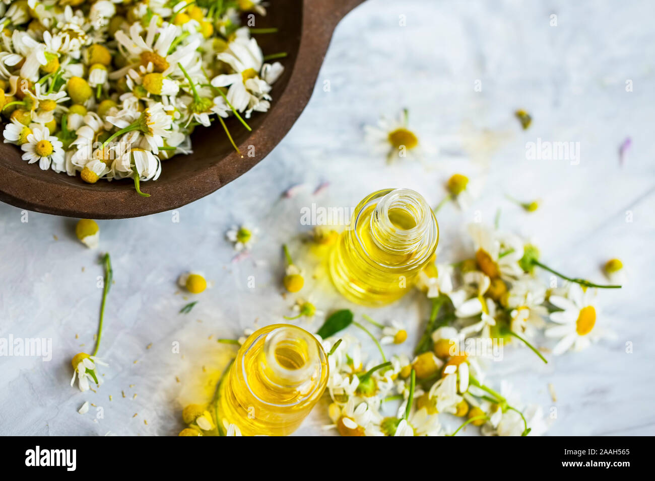 Chamomile oil , chamomile essential oil bottles with chamomile flowers