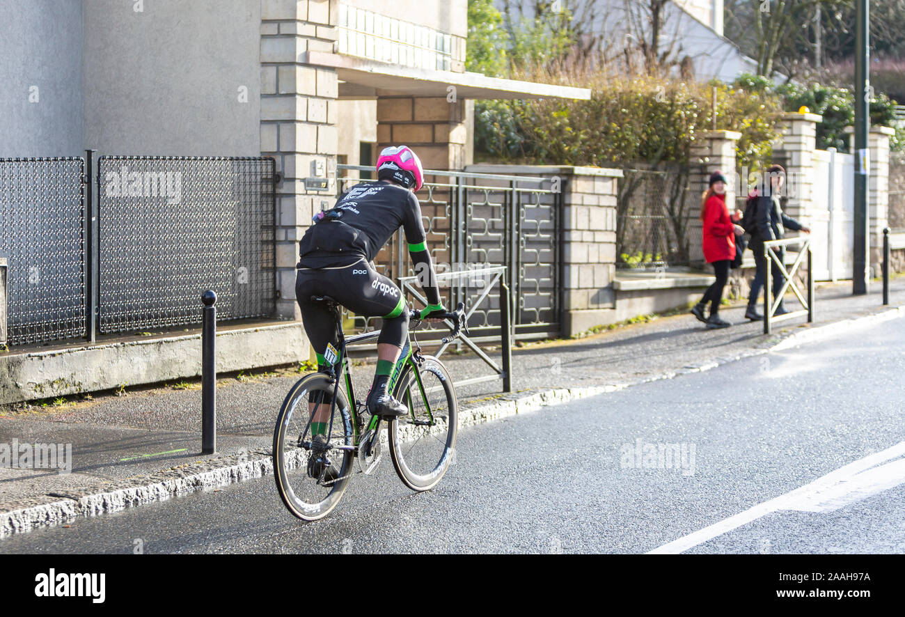 Meudon, France - March 4, 2018: Rear view of the New Zealand cyclist Tom Scully of  Team EF Education First-Drapac Cannondale riding during Paris-Nice 2018. Stock Photo