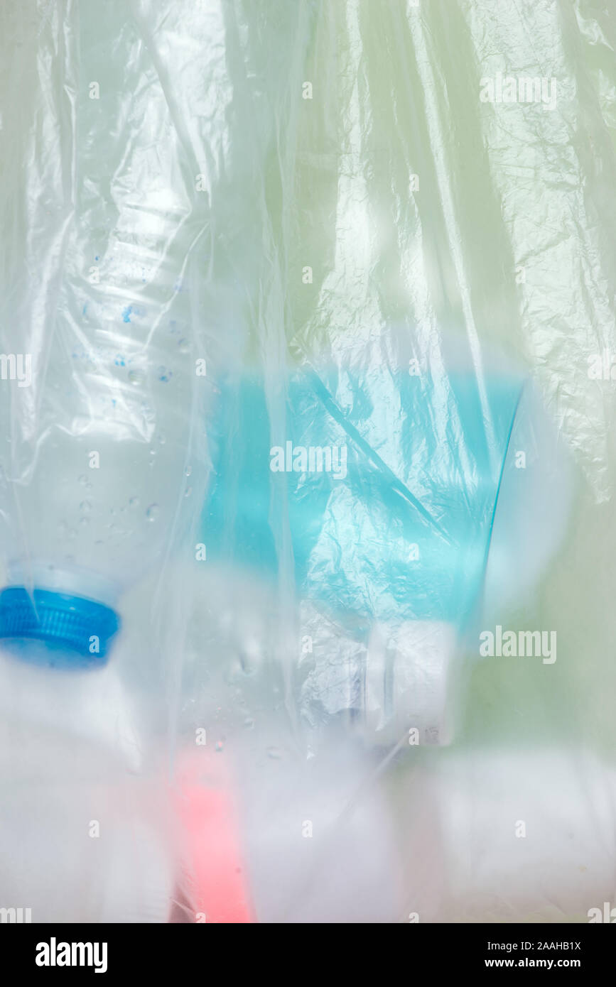 Plastic bag filled with household waste isolated on white background
