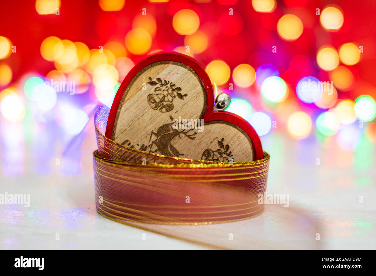 Wooden Heart Shaped Christmas Ornament Surrounded By A Colorful