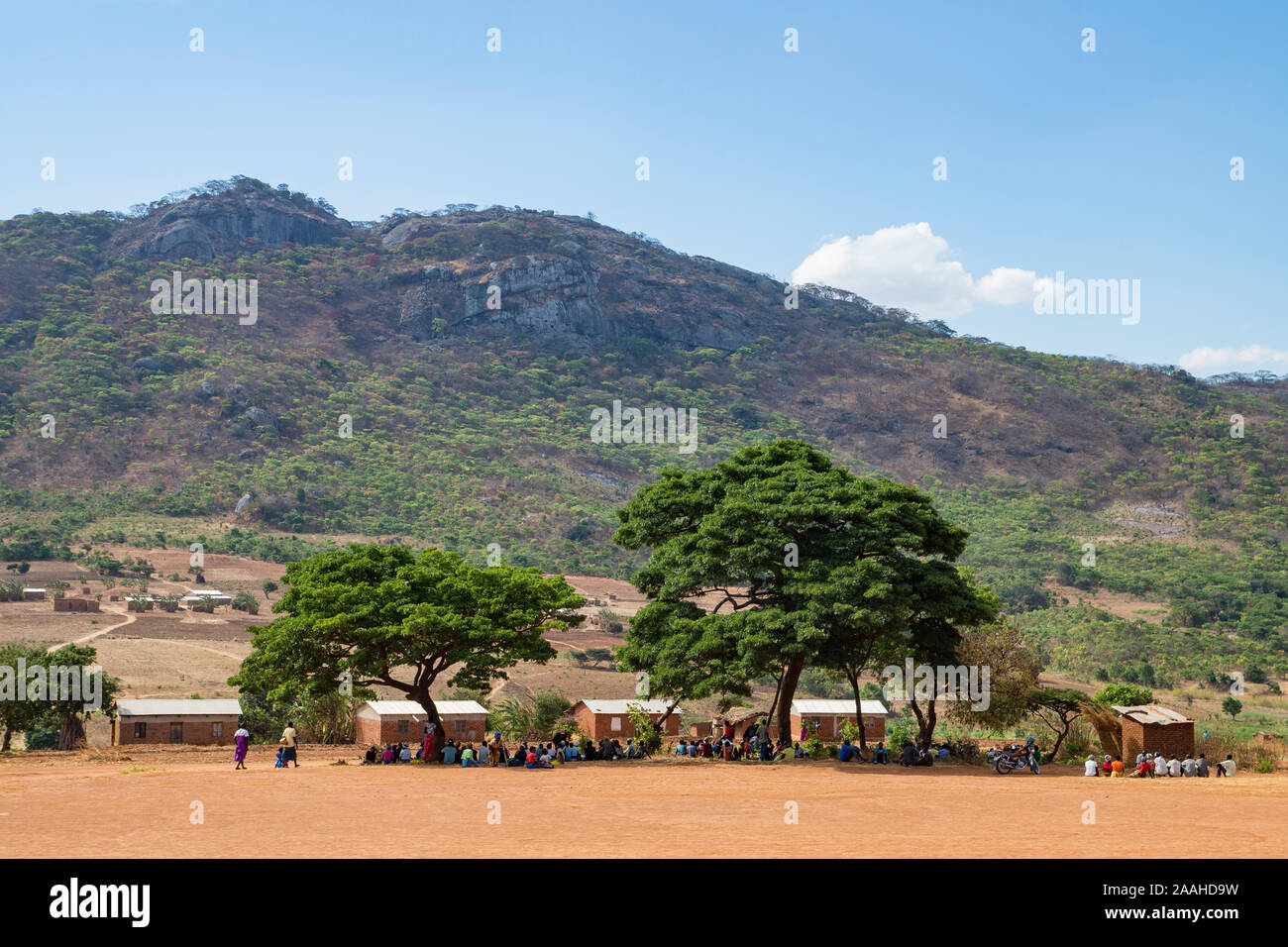 Village meeting under tree cover in a remote part of northern Malawi Stock Photo