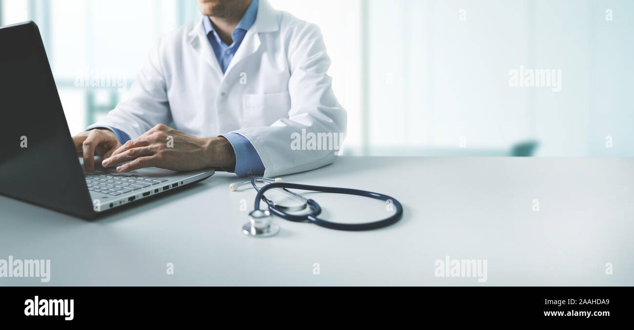 online medical consultation - doctor working on laptop computer in clinic office. copy space Stock Photo