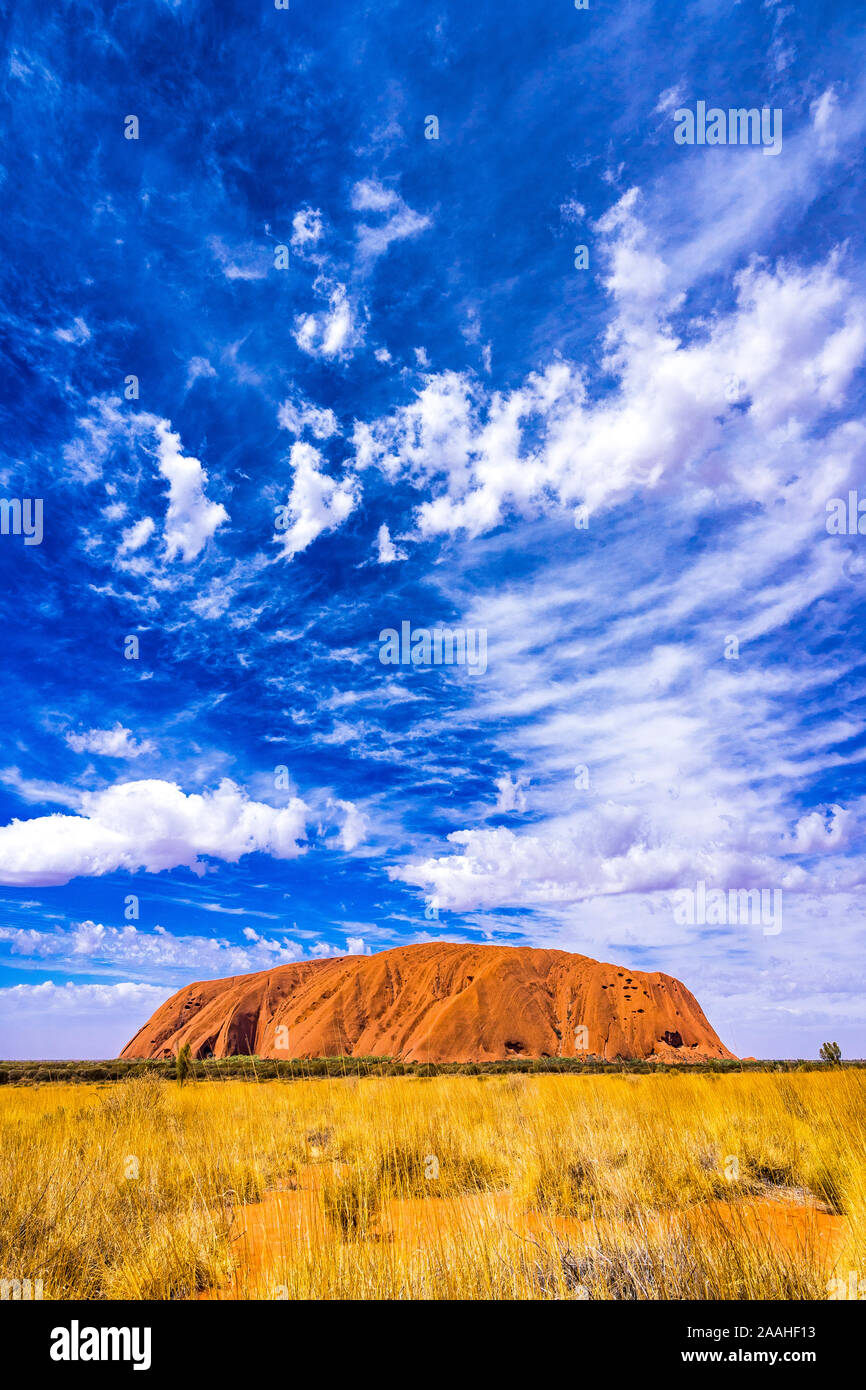 luru, Ayers Rock, on a sunny day with a magical cloud formation above Stock Photo