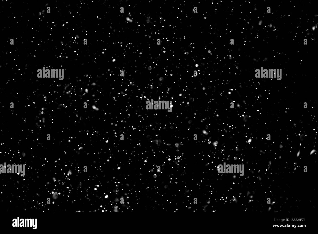 Snow on black background Stock Photo - Alamy