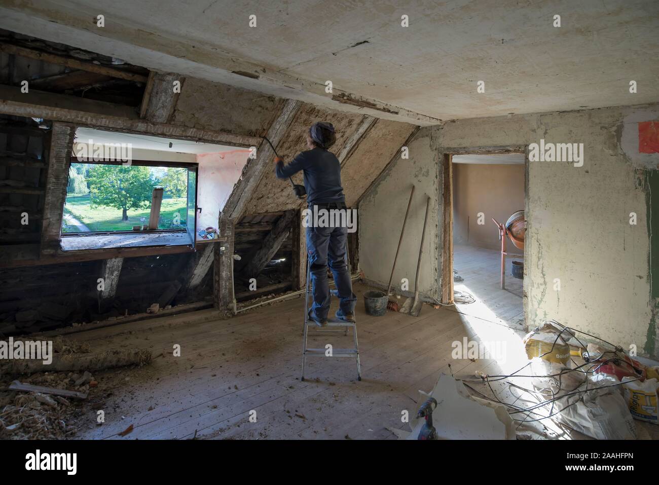 Woman in the attic extension of an old house, renovation, refurbishment, Mecklenburg-Western Pomerania, Germany Stock Photo