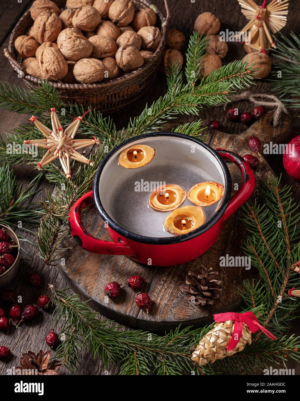 Candles made from nut shells floating in water - old Christmas custom Stock Photo