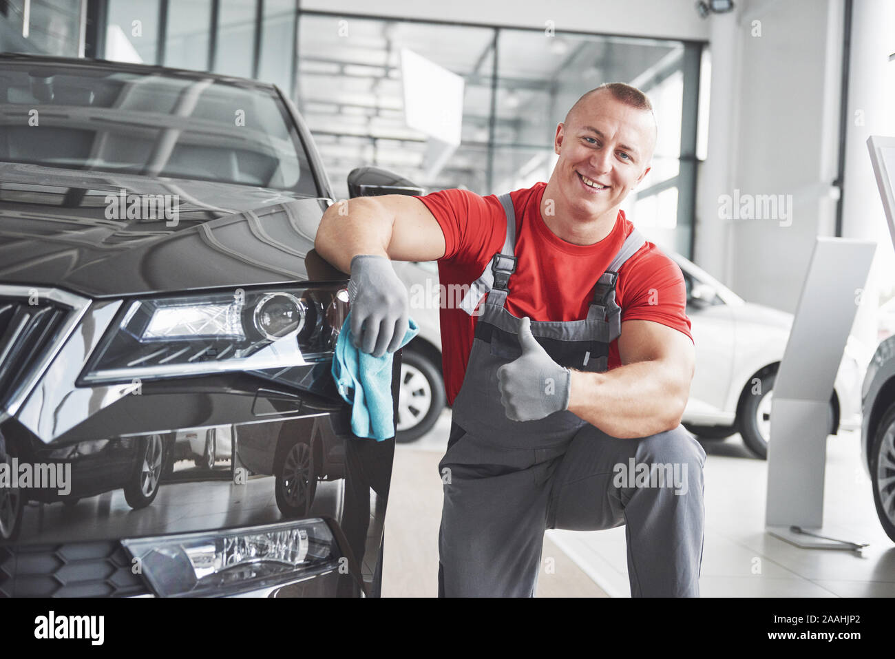 Professional cleaning and car wash in the car showroom Stock Photo - Alamy