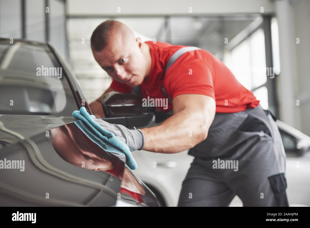 Professional cleaning and car wash in the car showroom Stock Photo - Alamy