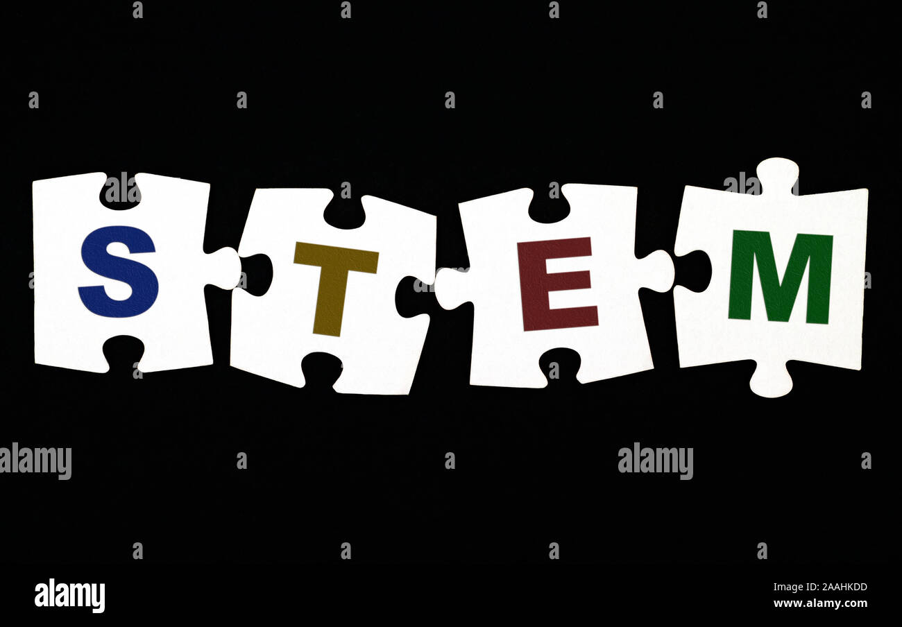 Four pieces of puzzle with letters STEM (Science, Technology, Engineering  and Mathematics) on black background. Close-up Stock Photo - Alamy