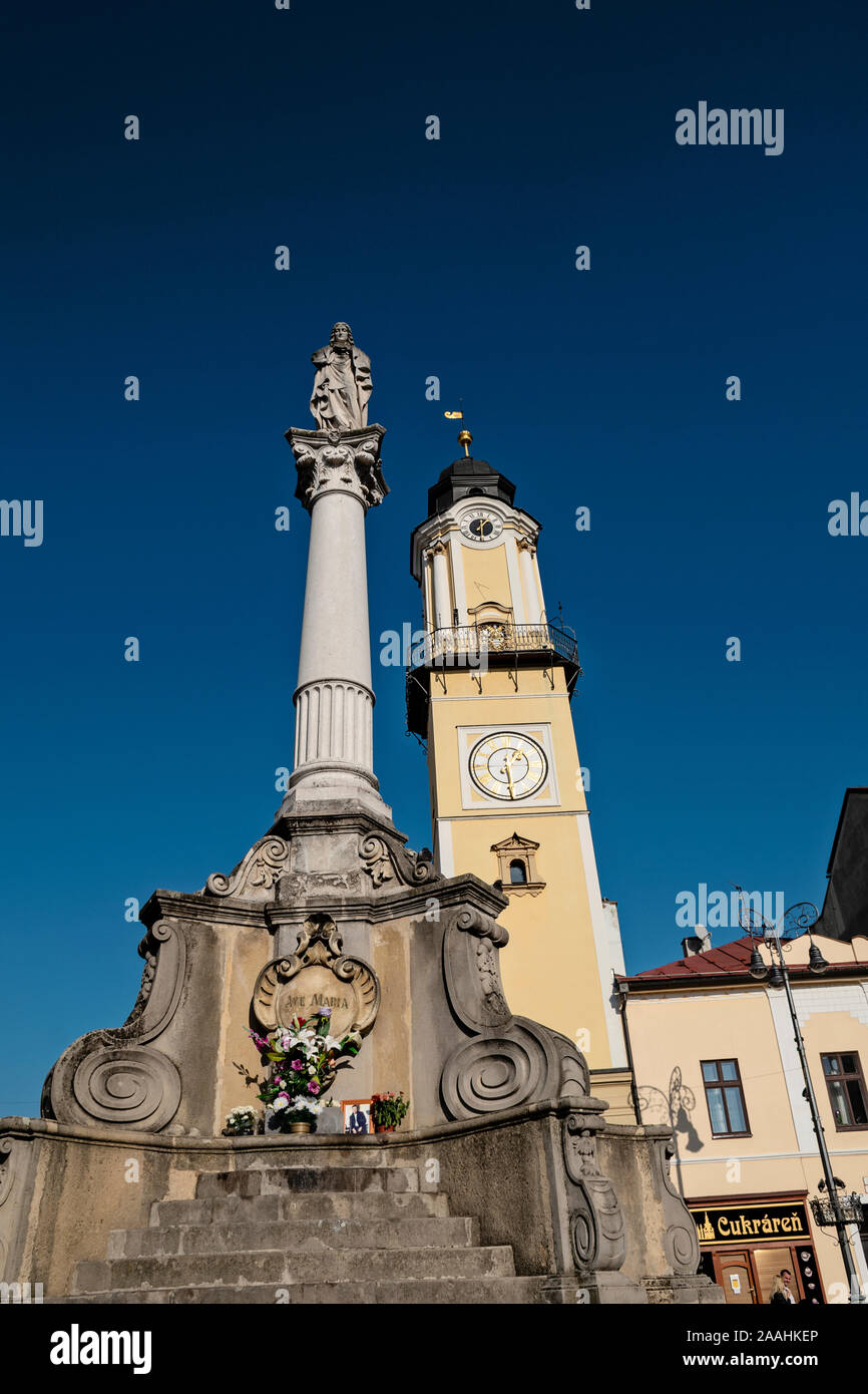 Banska Bystrica, Slovakia - October 27, 2019: Main square of Slovak National Uprising on sunny day. View on marian column and city clock tower on hist Stock Photo
