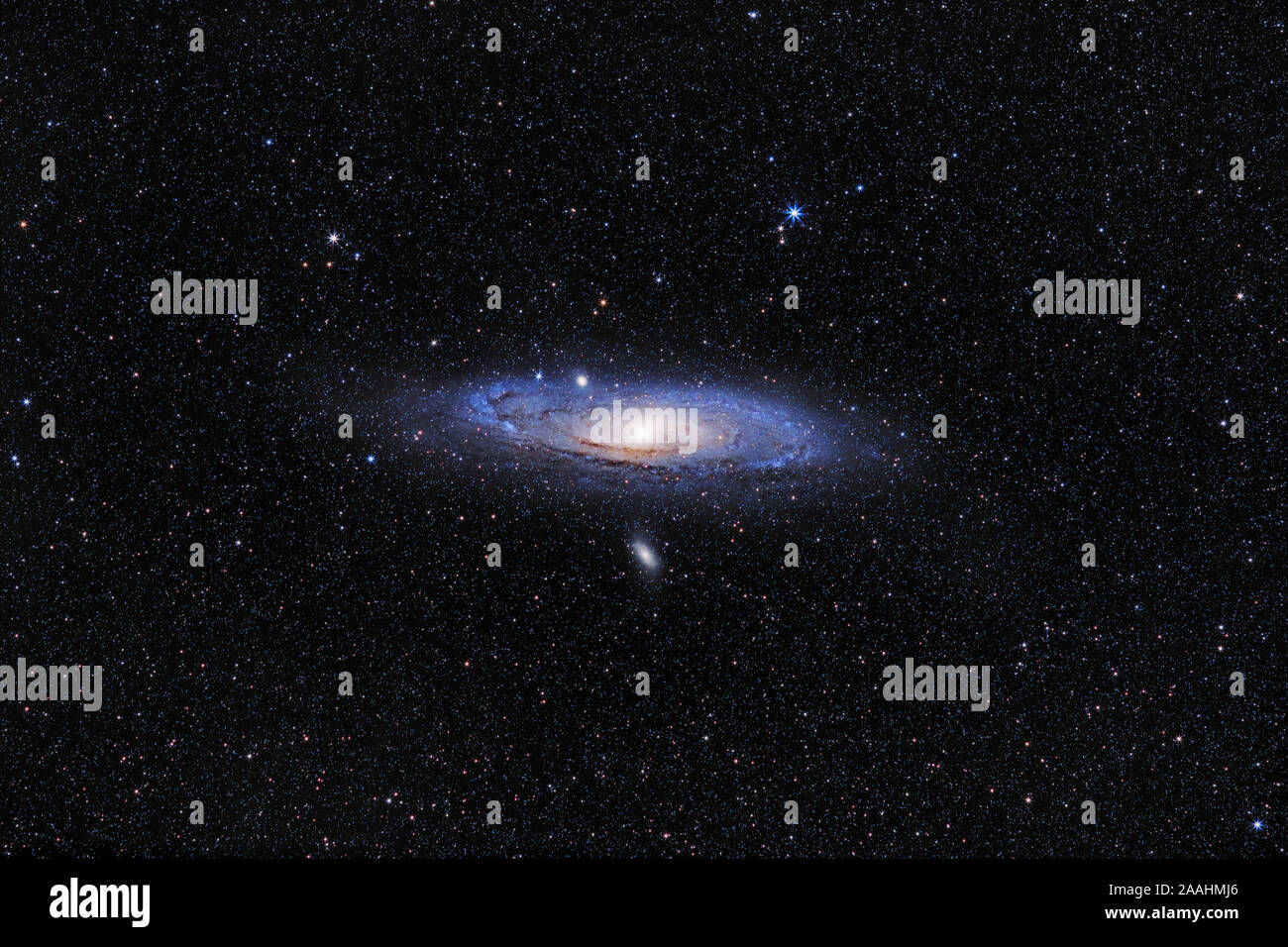 Andromeda Galaxy (M31) and its satellite galaxies (M32 and M110) in Andromeda constellation against widefield starry sky Stock Photo