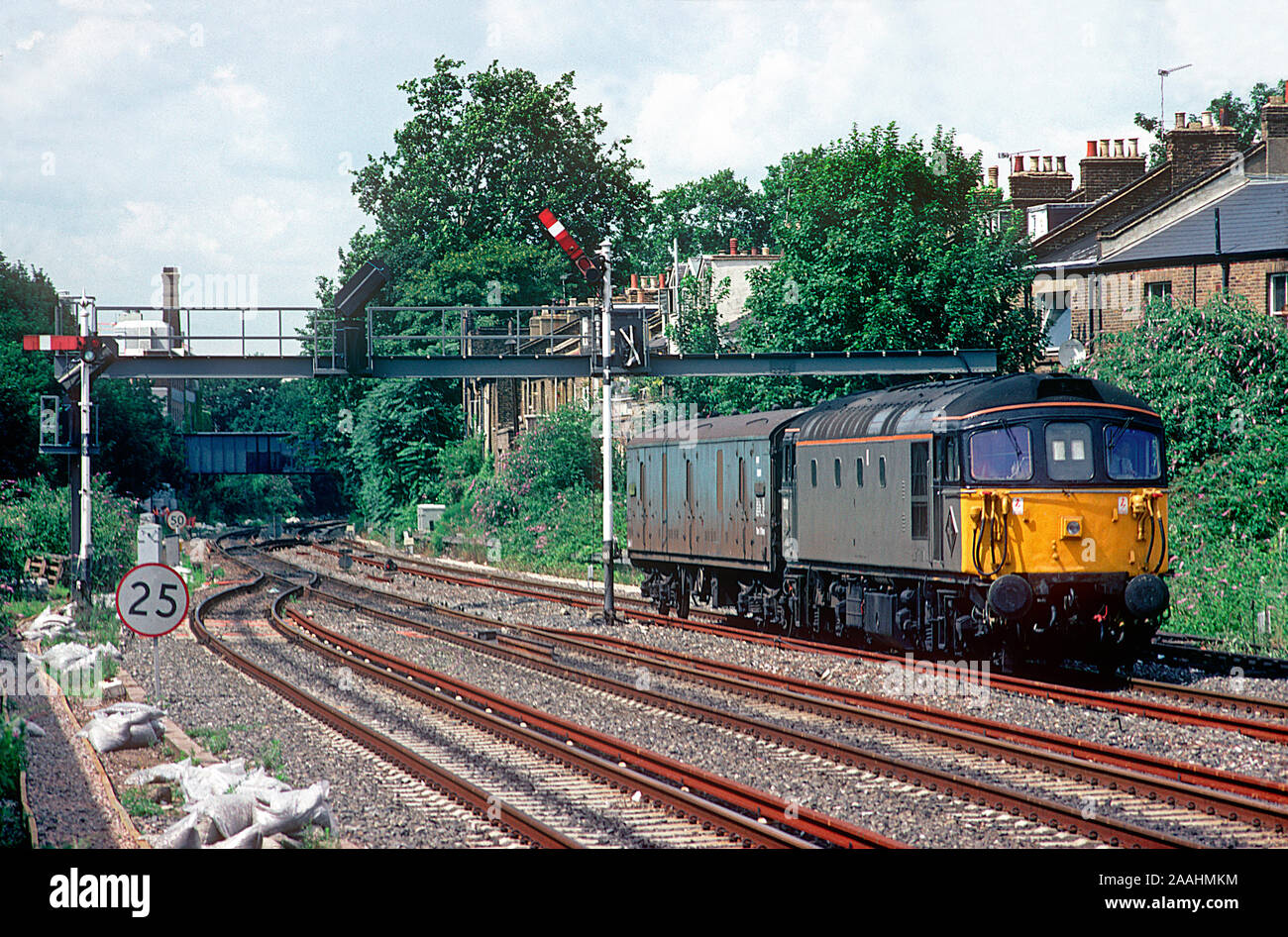 A class 33 Crompton diesel locomotive number 33101 heads through Kensington Olympia with a single mail van in tow. Stock Photo