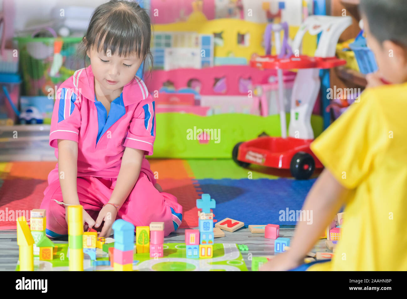 Asian little girl child playing in space toys for children develop in preschool, also known as nursery school Stock Photo