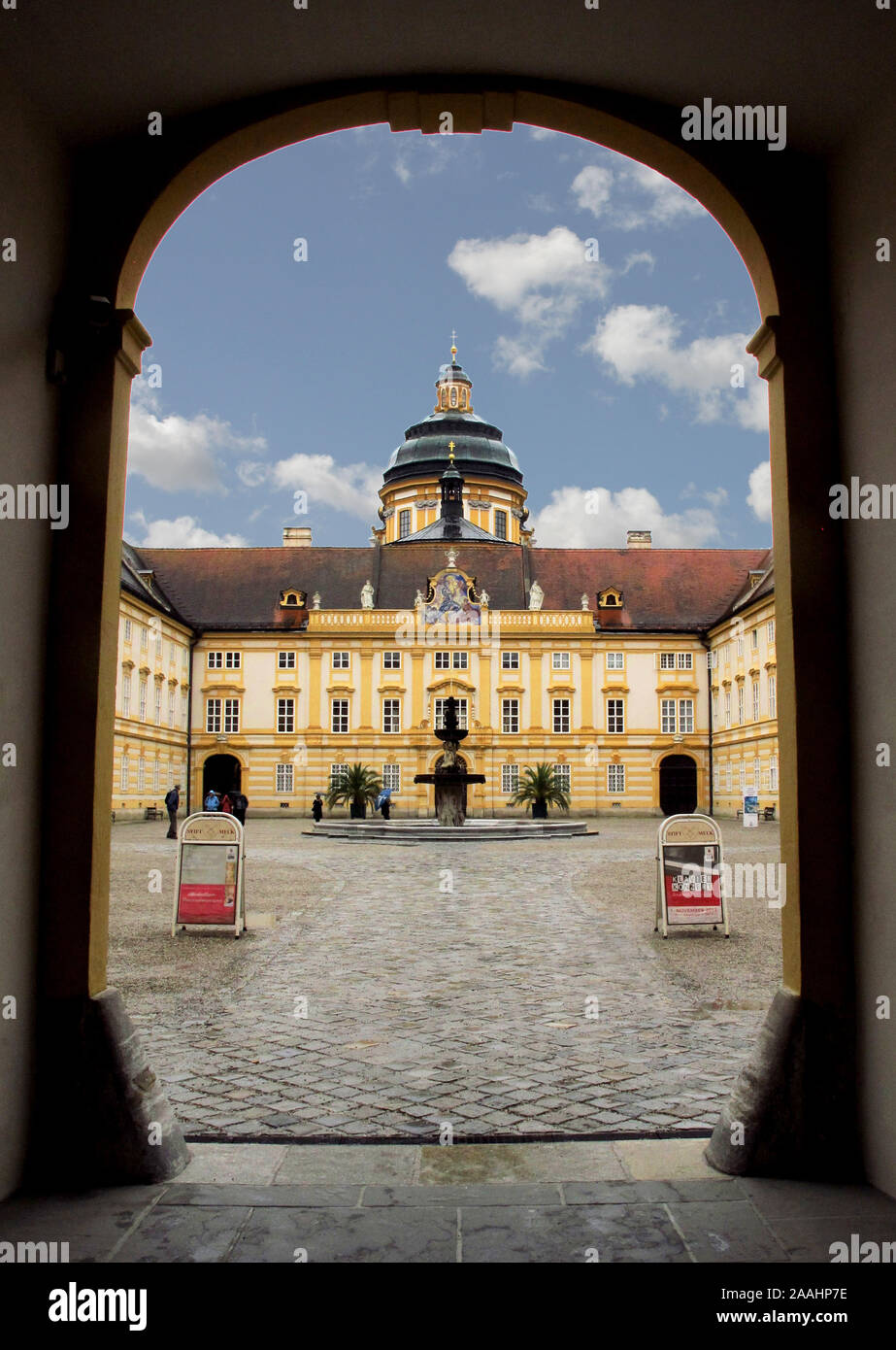 The dome and courtyard  of Melk Abbey, seen through an archway, a Benediction Monastery on the hill top above Melk in Austria Stock Photo