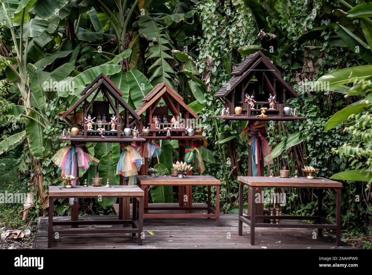 Spirit house and tree roots intertwined. Miniature house for guardian ... - Spirit Shared Wooden Structure