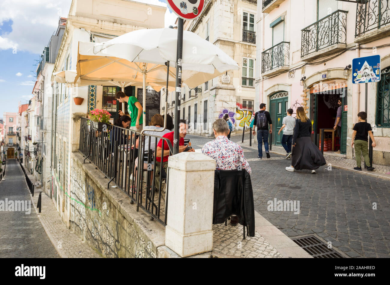 Lisbon, Portugal - May, 30th, 2018 : People sit at a sidewalk cafe at Rua Marechal Saldanha street, near  Santa Catarina viewpoint. Stock Photo