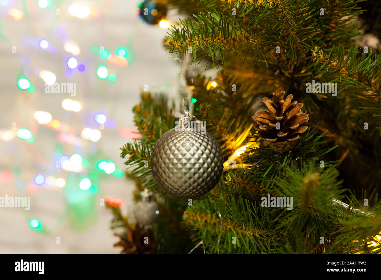 Beautiful green Christmas tree decorated with balls and garlands. Close ...