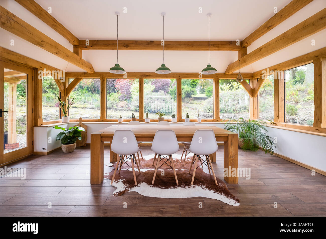 Stylish beautiful oak garden room with dining table Stock Photo