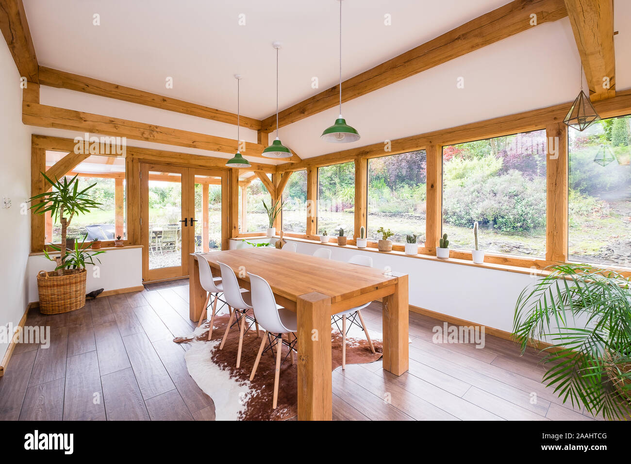 Oak framed garden room with modern dining table table Stock Photo