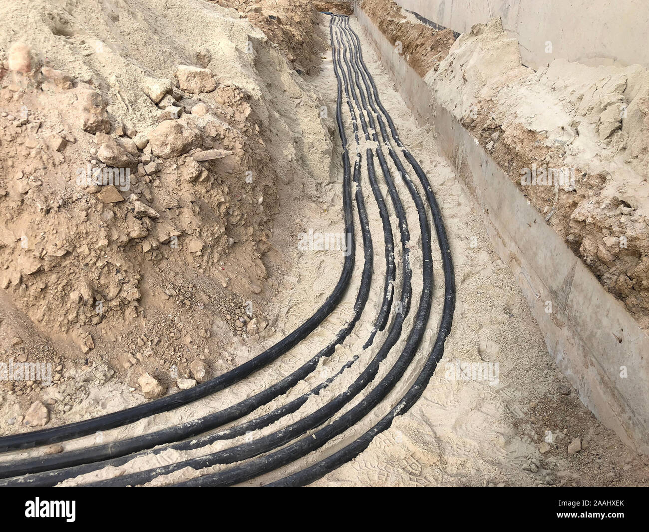 The high voltage electrical cable is laid in a trench Stock Photo - Alamy
