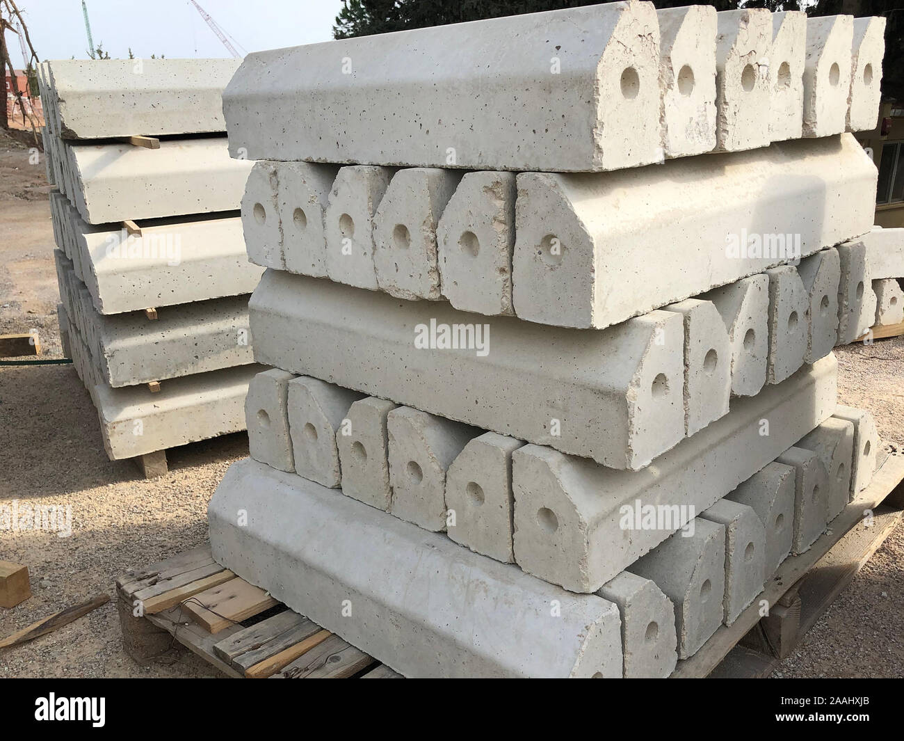 Piled concrete curbstones. Construction material for road construction works. Stock Photo