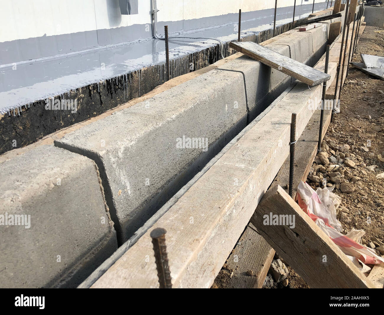 Concrete curbstones installation. Grouting of sidewalk pavement borders