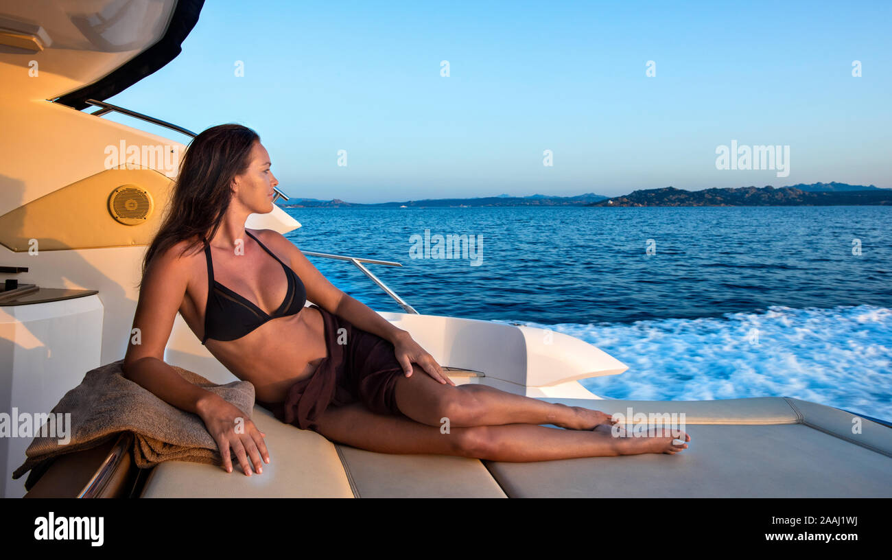 Woman in bikini relaxing on yacht Stock Photo - Alamy
