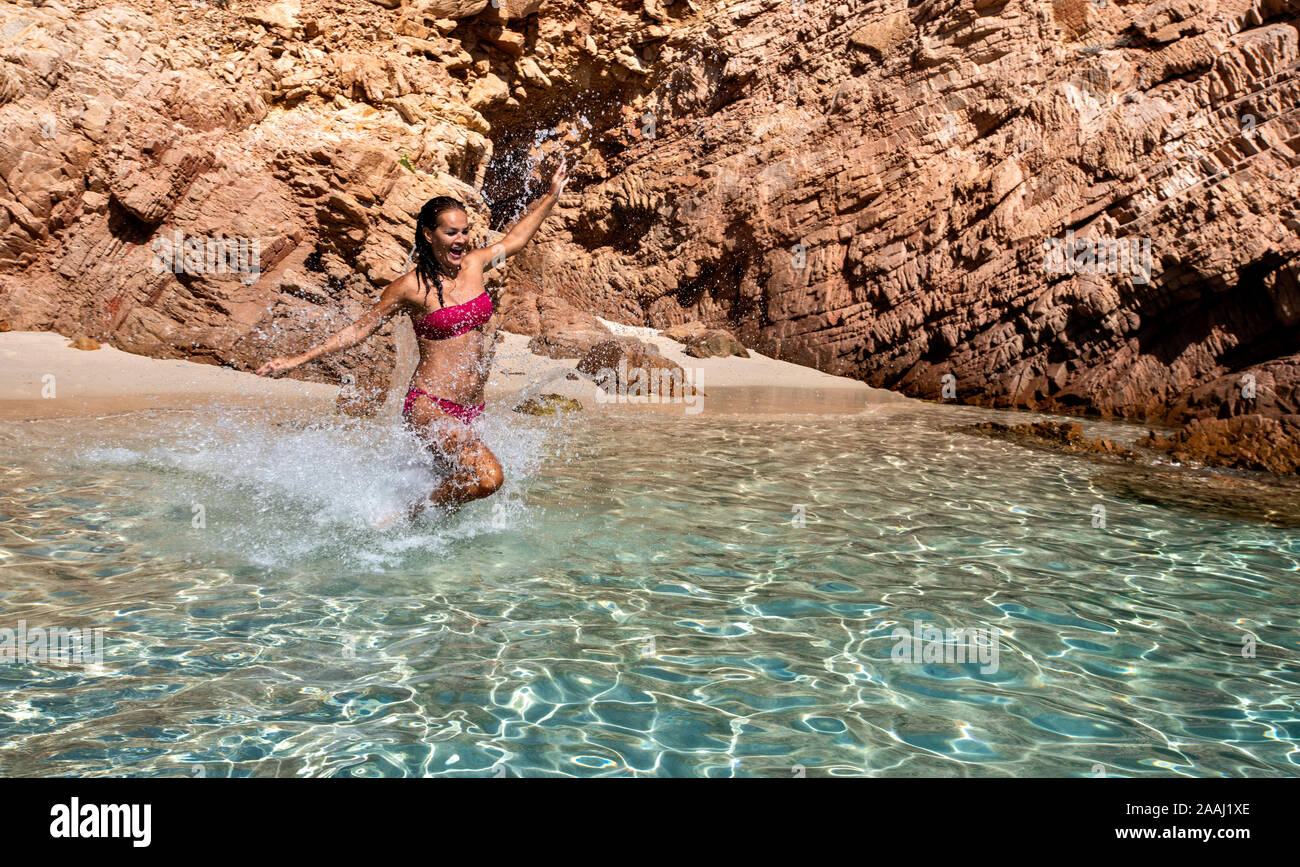Woman in bikini enjoying clear sea water in lagoon, La Maddalena island,  Sardegna, Italy Stock Photo - Alamy