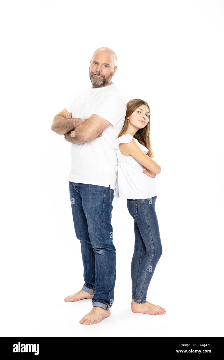 Father and daughter with arms crossed, white background Stock Photo