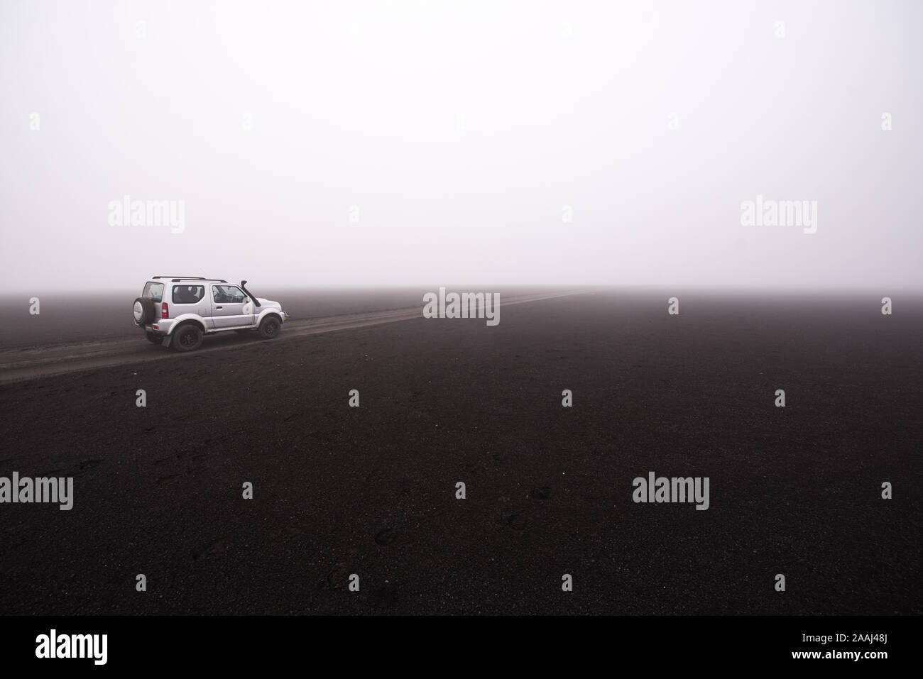 Off road vehicle on dirt track in foggy conditions, Landmannalaugar, Iceland Stock Photo