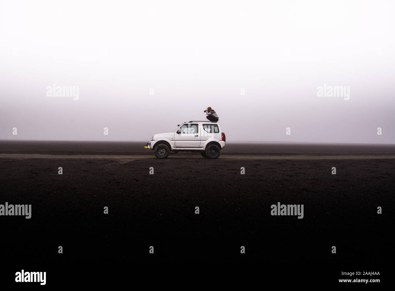 Woman photographing from top of off road vehicle, Landmannalaugar, Iceland Stock Photo