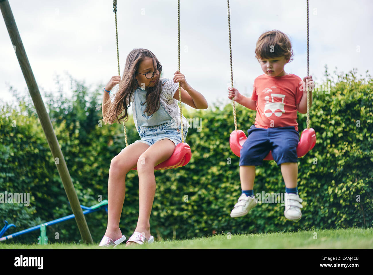 Brother and sister playing swing hi-res stock photography and images ...