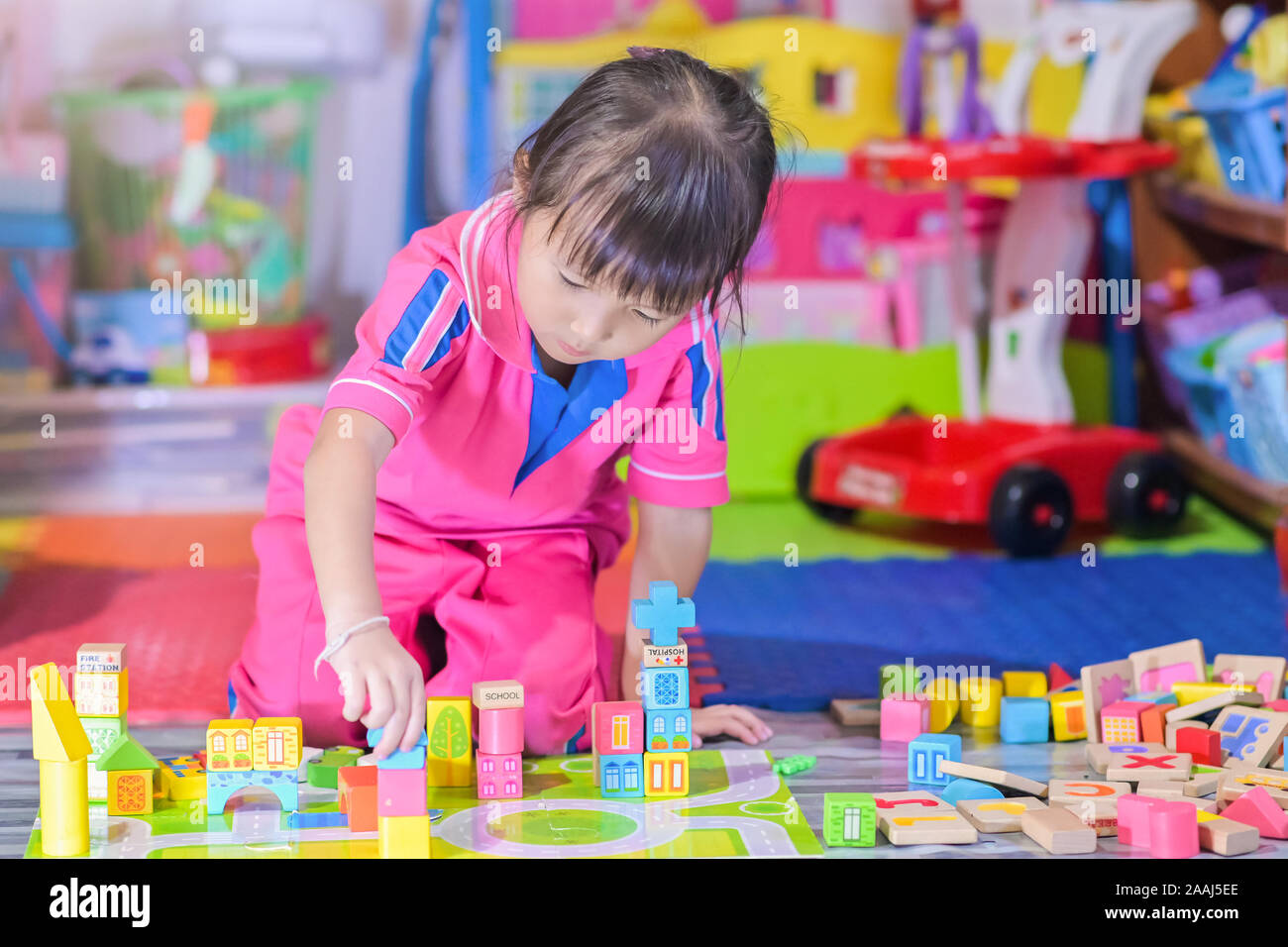Asian little girl child playing in space toys for children develop in preschool, also known as nursery school Stock Photo